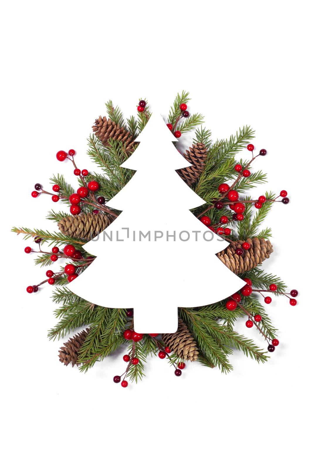 Christmas white fir tree shaped blank card with copy space and decor of fir tree branch bauble cones red holly berry isolated on white background