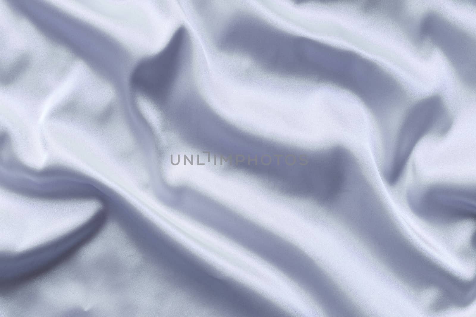 Smooth elegant blue silk with soft folds can be used as background.