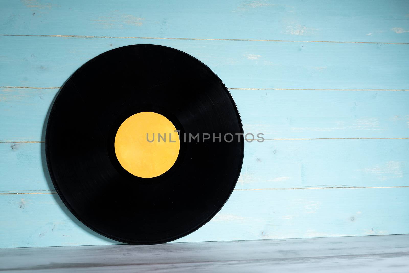 Vinyl record on blue wooden background by Robertobinetti70