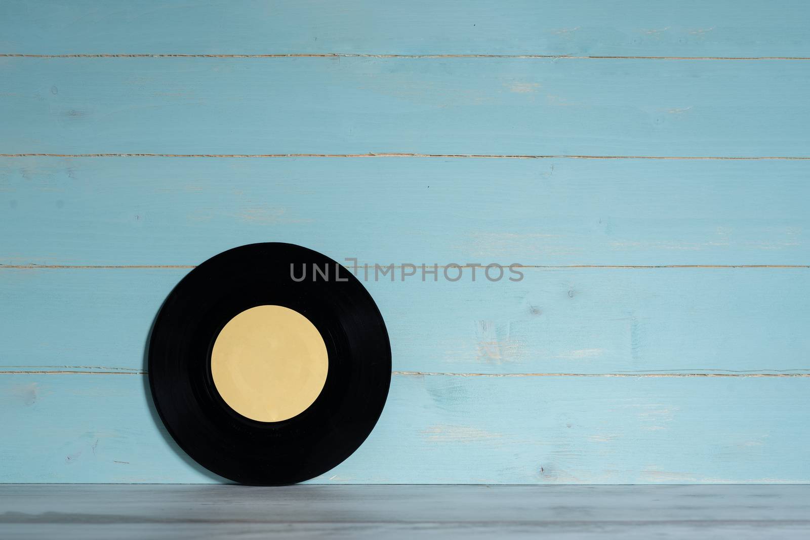 Vinyl record on blue wooden background by Robertobinetti70