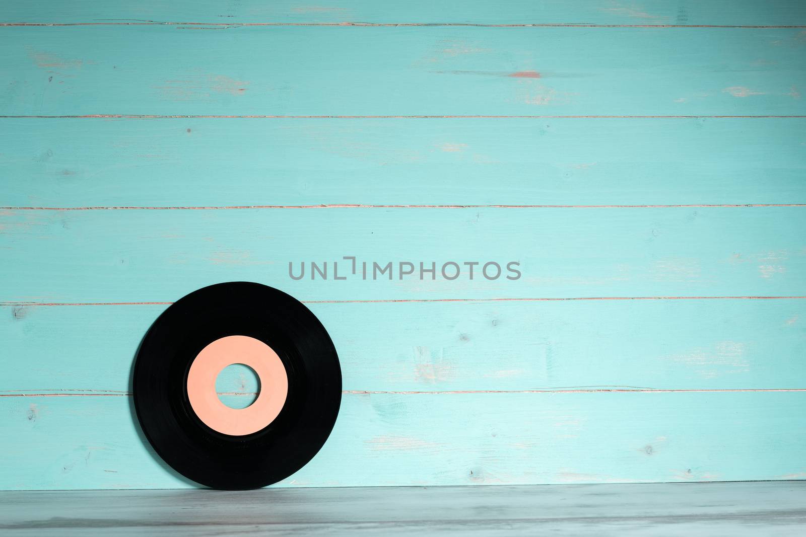 Vinyl record on green wooden background by Robertobinetti70