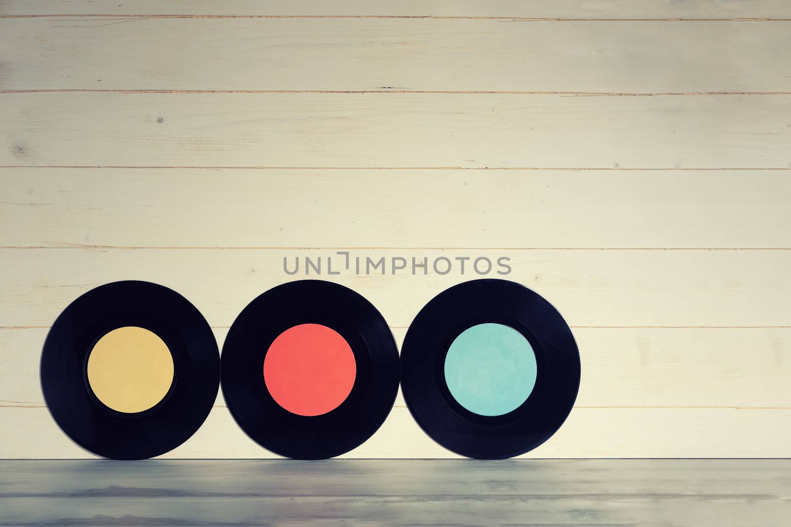 Vinyl records on beige wooden background by Robertobinetti70