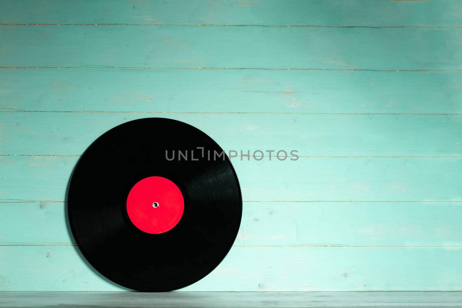 Vinyl record on green wooden background by Robertobinetti70