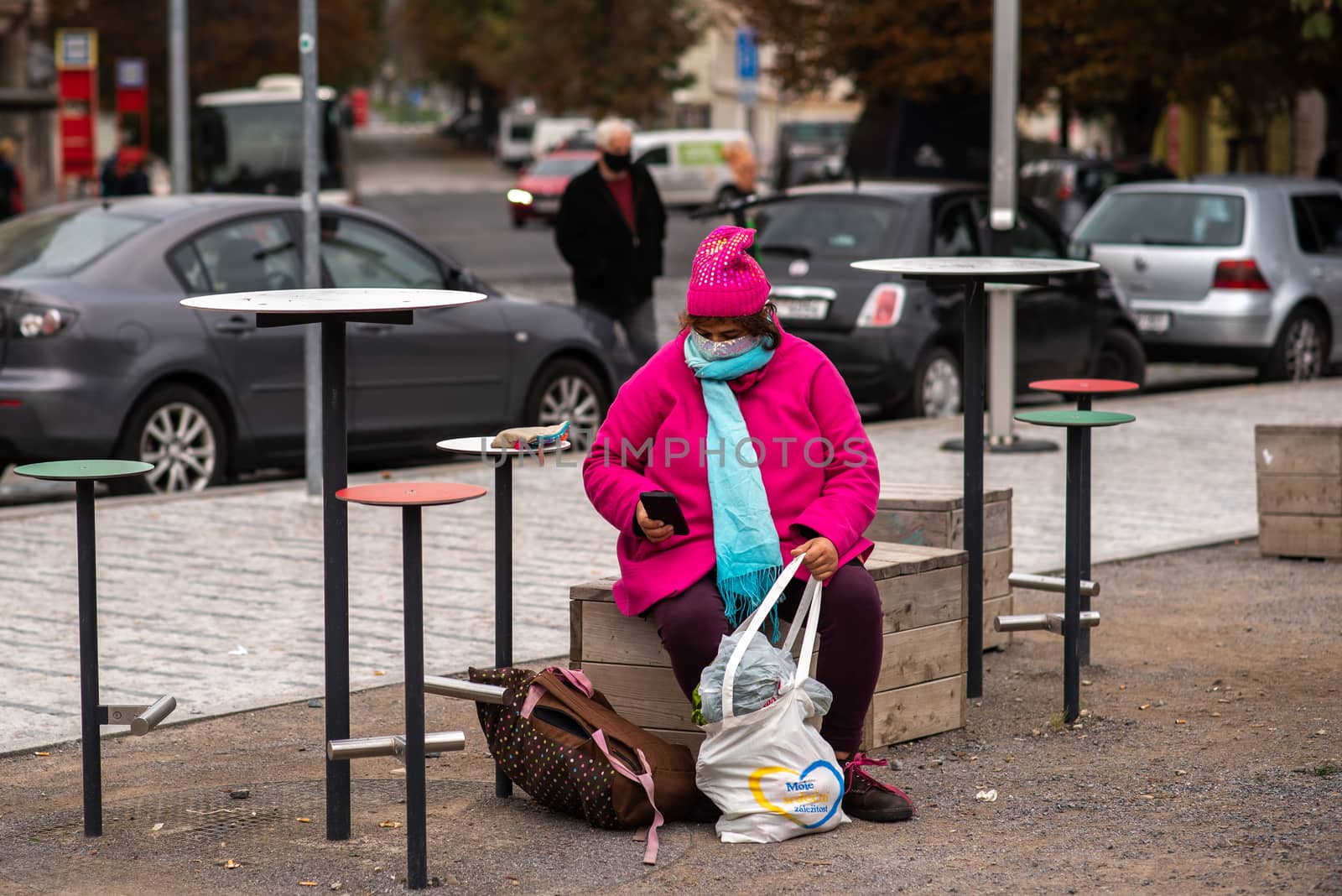 11/05/2020. Prague, Czech Republic. Woman carrying a mask resting with heavy bags during quarantine period due to outbreak of COVID-19 as winter is starting. Prague, Czech Republic by gonzalobell