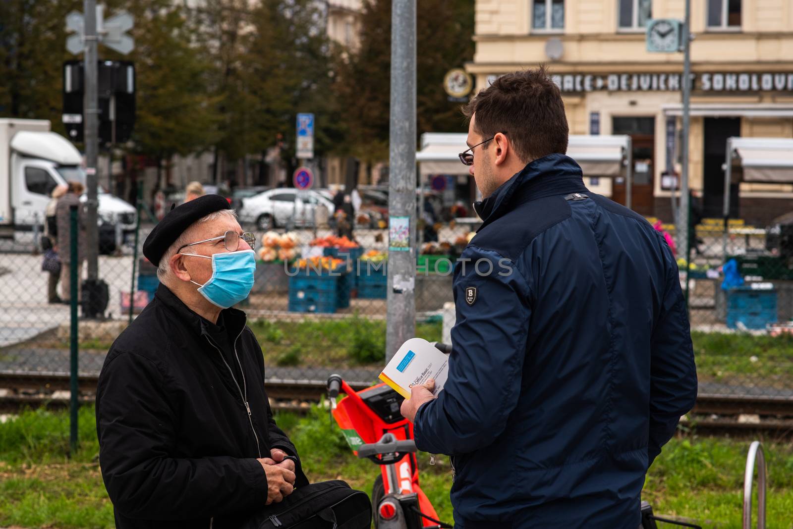 11/05/2020. Prague, Czech Republic. Two men (one with mask) are talking at Hradcanska metro station during quarantine period due to outbreak of COVID-19 as winter is starting. Prague, Czech Republic by gonzalobell