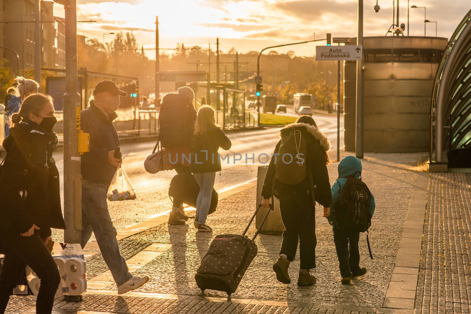 Family with mask is crossing the street at Hradcanska metro station during quarantine period due to outbreak of COVID-19 as winter is starting. Prague, Czech Republic