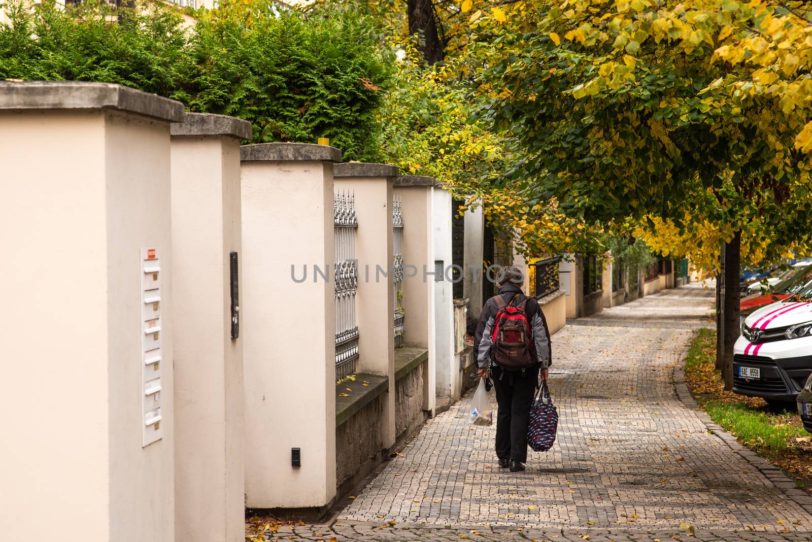 11/02/2020. Prague, Czech Republic. Woman is walking alone in Prague 7 district carrying her shopping bags during quarantine period due to outbreak of COVID-19 as winter is starting, Czech Republic by gonzalobell