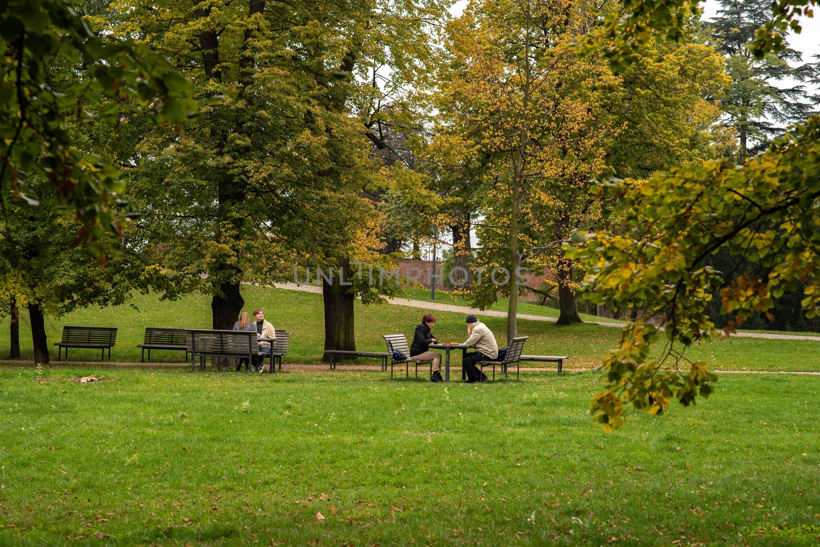 People are talking and playing chess on Letna Park in Autumn 2020 on Prague 6 during quarantine period due to outbreak of COVID-19 as winter is starting, Czech Republic by gonzalobell