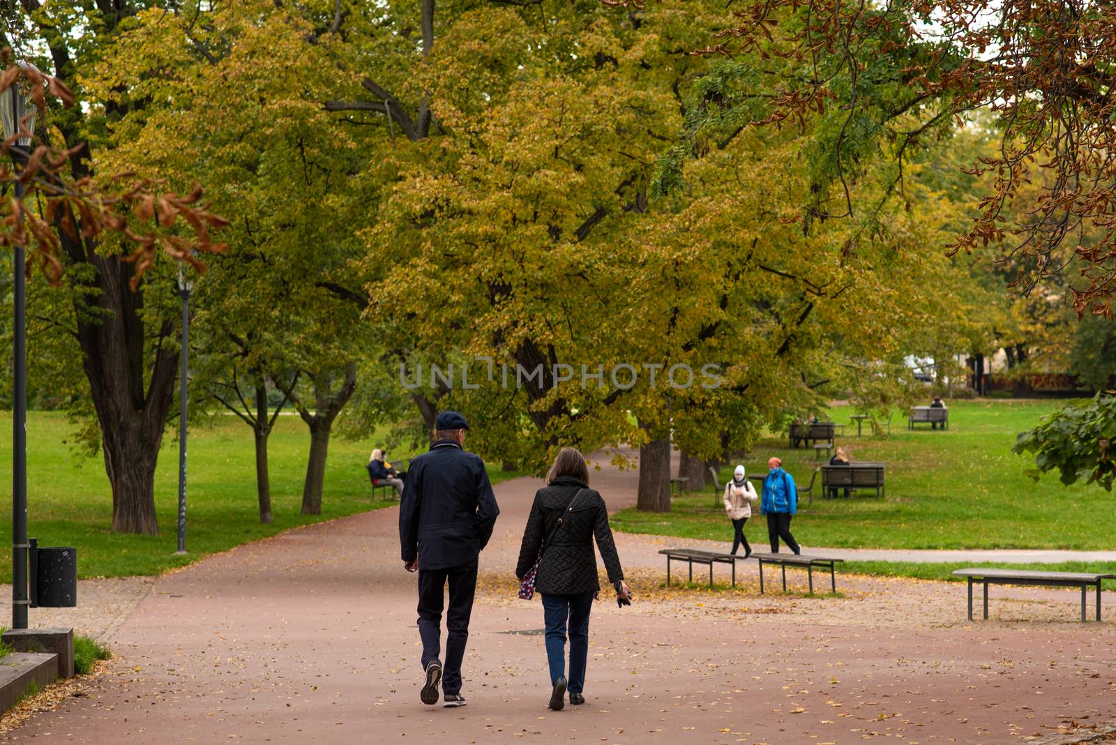 Man and woman are walking and talking on Letna Park in Autumn 2020 on Prague 6, during quarantine period due to outbreak of COVID-19 as winter is starting, Czech Republic