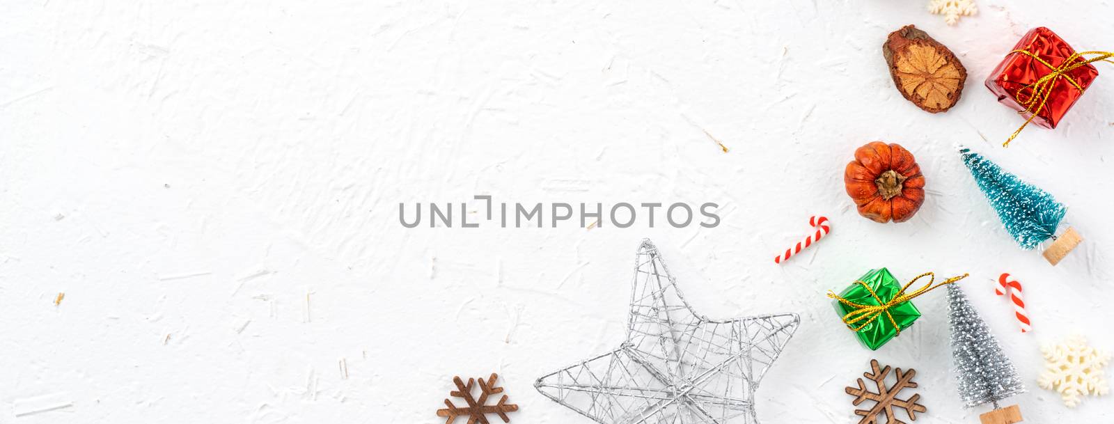 Top view of Christmas holiday decoration ornament composition with Christmas tree, gift star, gingerbread man flat lay with copy space isolated on white background.