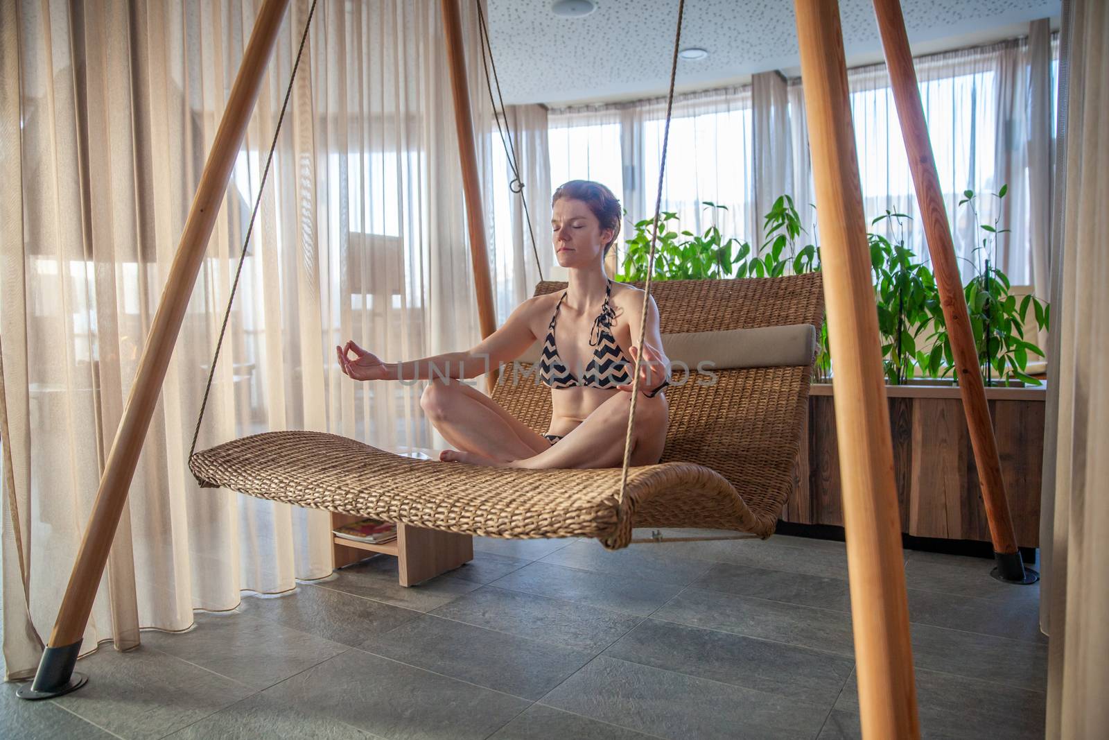 young woman meditating in a relaxation center by Edophoto