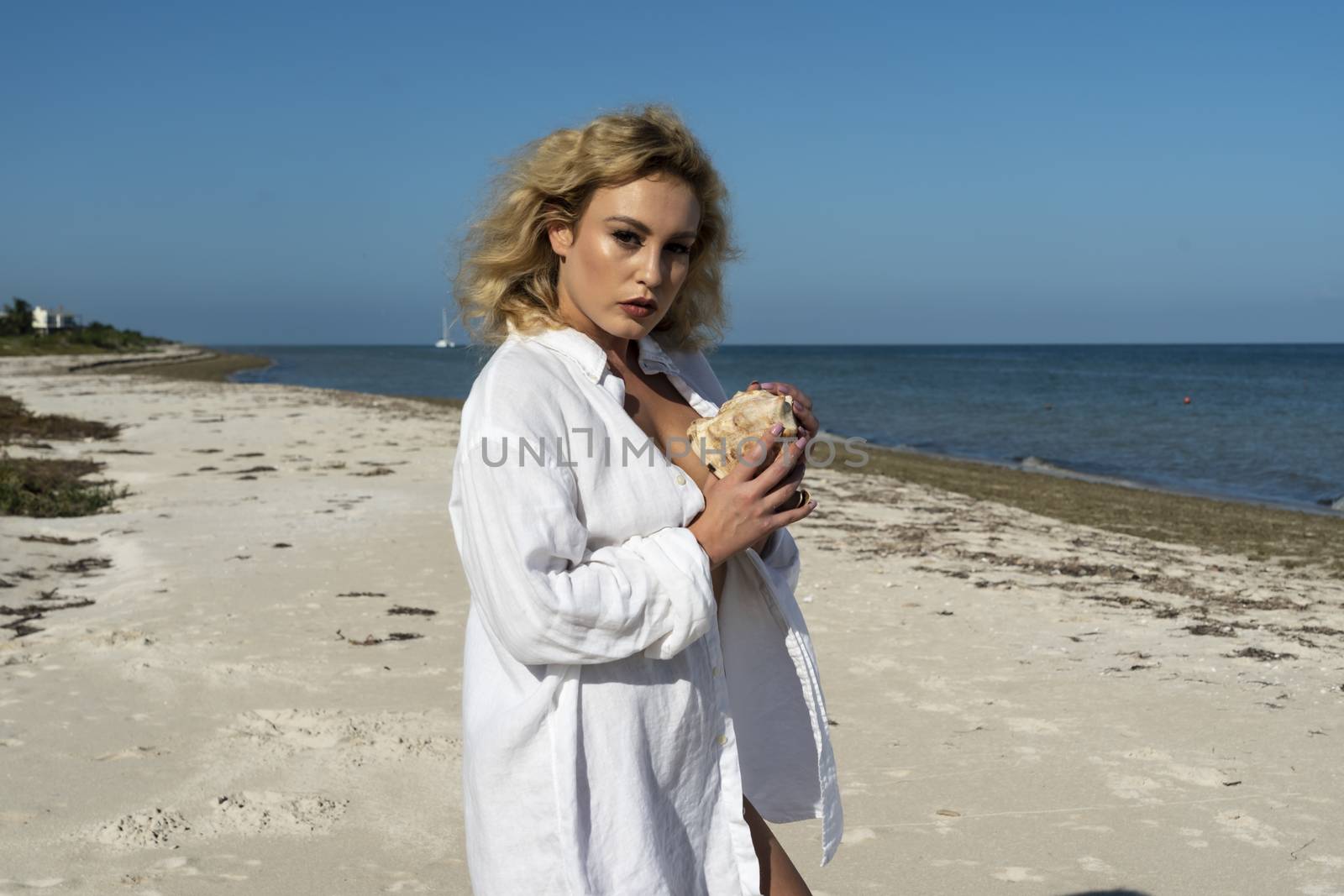 A beautiful blonde model poses nude on an exotic beach in the Yucatán Peninsula near Merida, Mexico