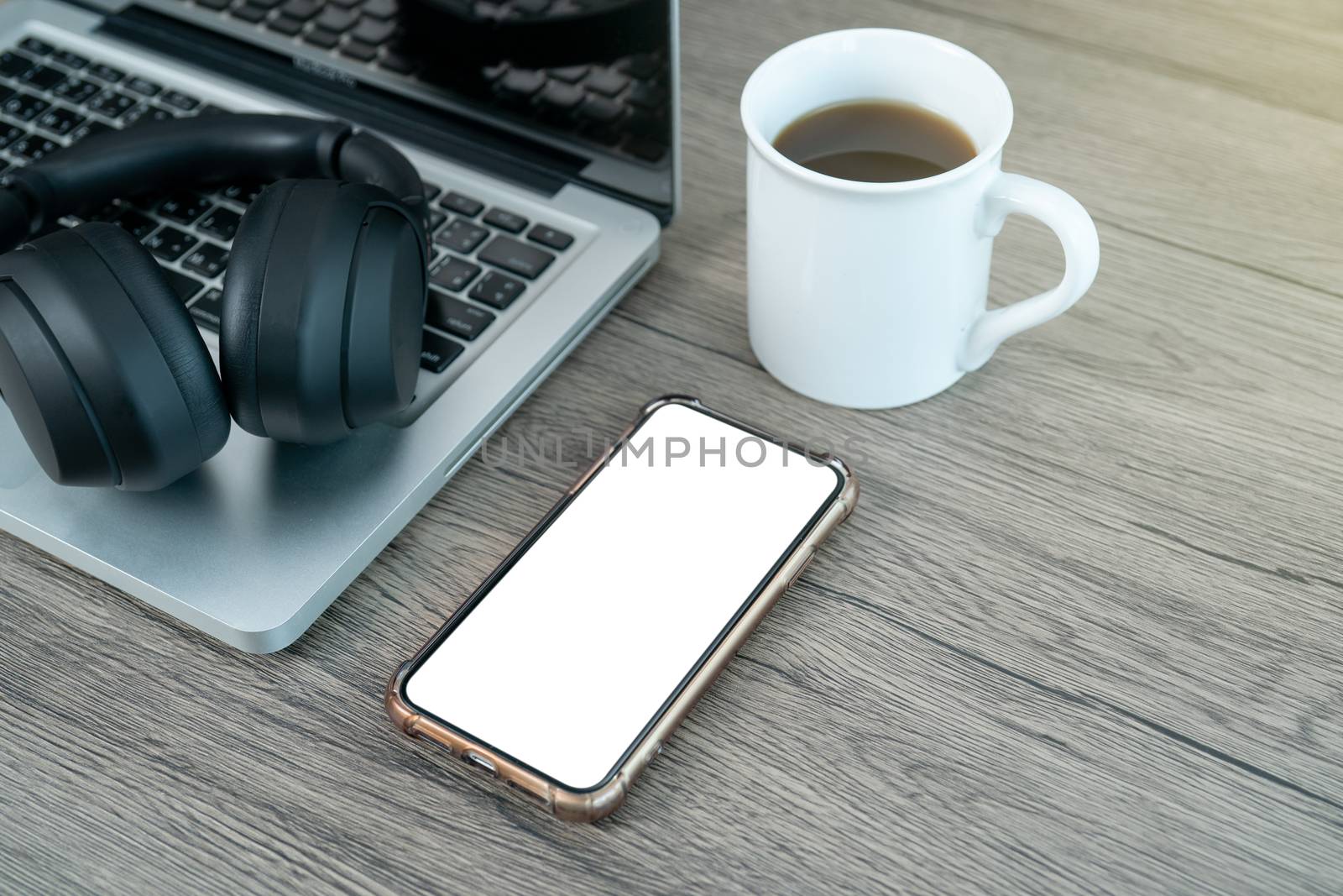 smart phone white mock up screen. Working place office desk. Flat lay workspace with laptop cup of coffee on wooden background.