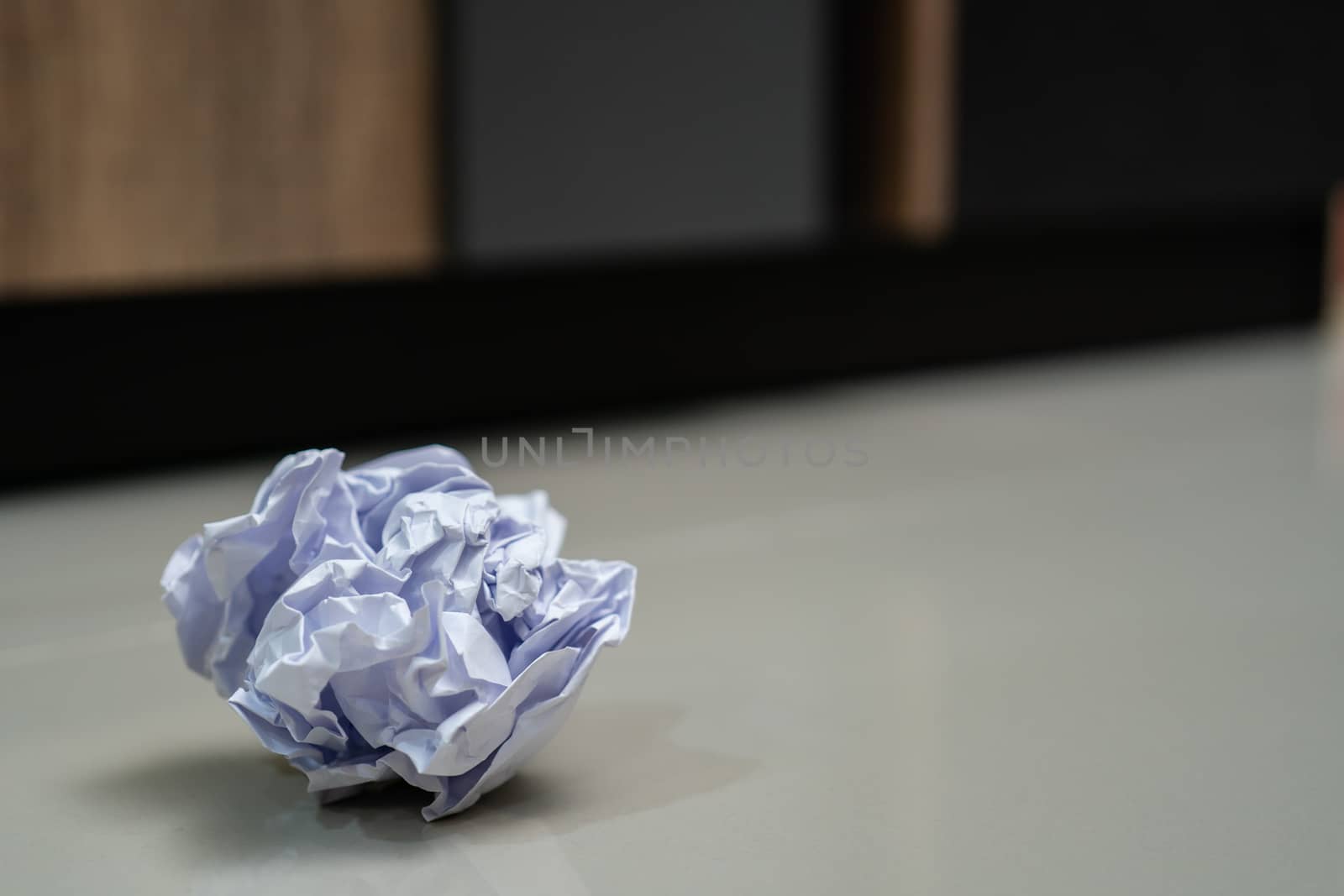 Crumpled balls of white paper on the floor.