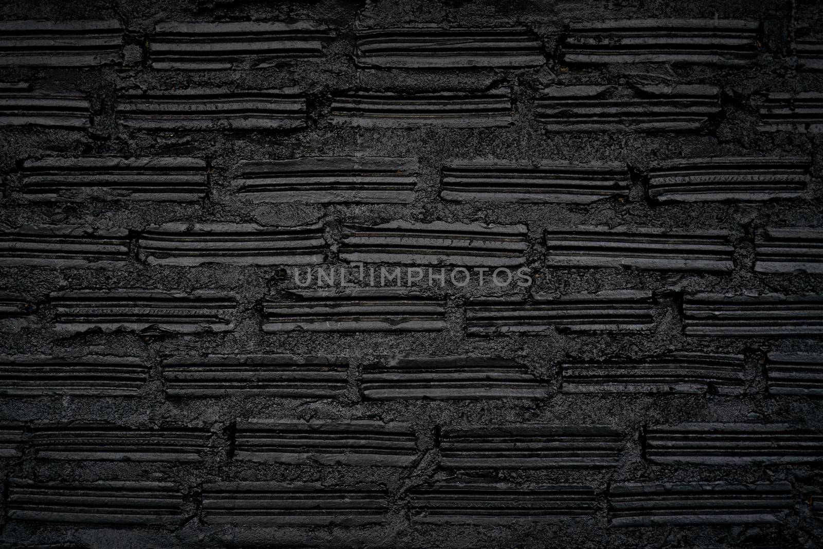 Old black brick wall background. Vintage background.