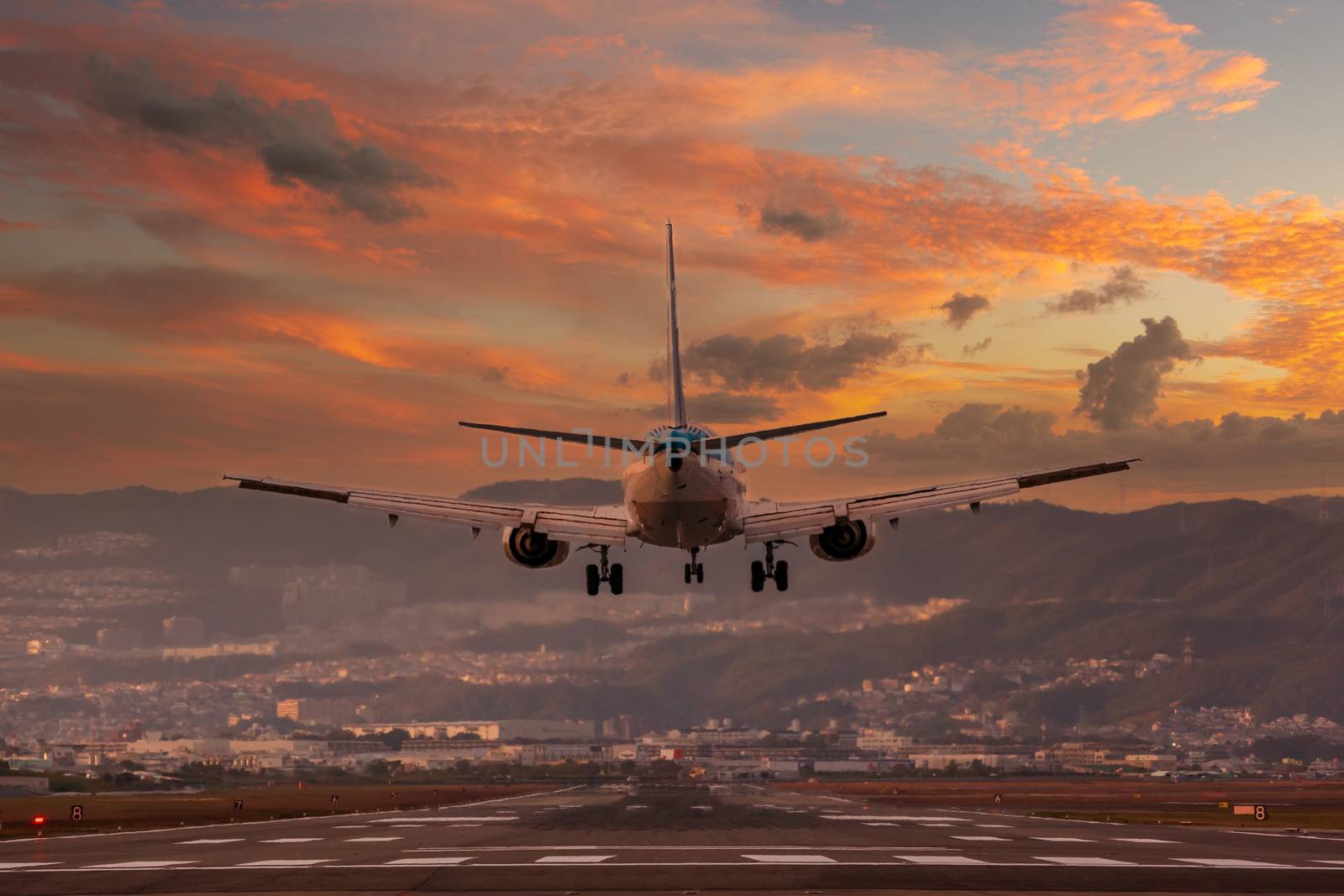 big plane landing at Osaka-Itami International Airport during sunset, Japan