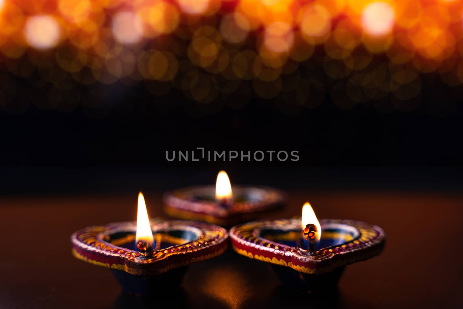 Indian festival Diwali, Diya oil lamps lit on colorful rangoli. Hindu traditional. Happy Deepavali. Copy space for text.