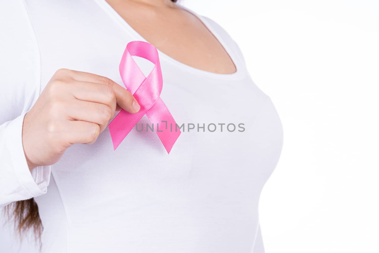 Breast cancer awareness ribbon on woman chest isolated over white background. Medical, healthcare for advertising concept.
