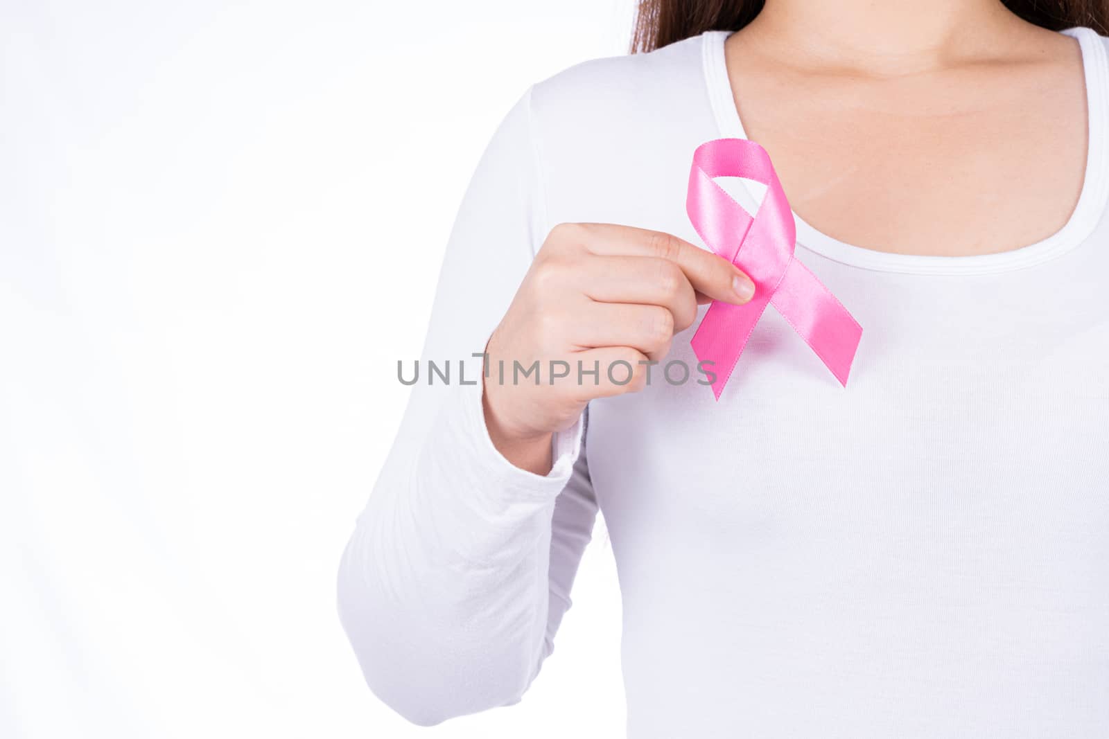 Breast cancer awareness ribbon on woman chest isolated over white background. Medical, healthcare for advertising concept.