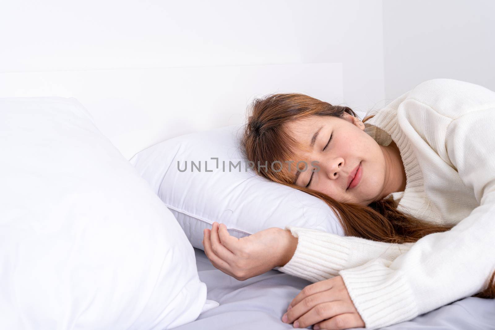 Asian woman sleeping in the bed and relaxing in a good mood happy dream. Healthcare medical or daily life concept.