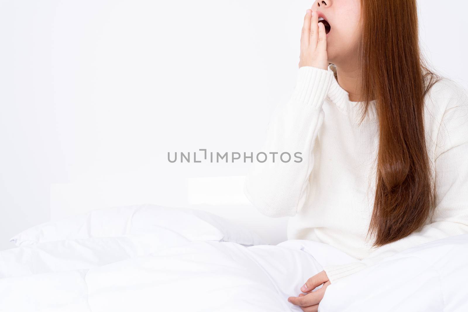 Asian woman are yawning covering open mouth with hand after she wake up. Healthcare medical or daily life concept.