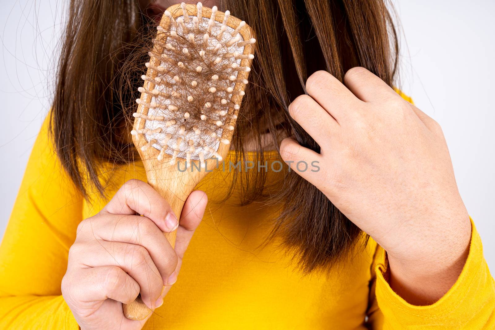 Hair fall problem, closeup hand holding comb and problem hair. Healthcare medical or daily life concept.