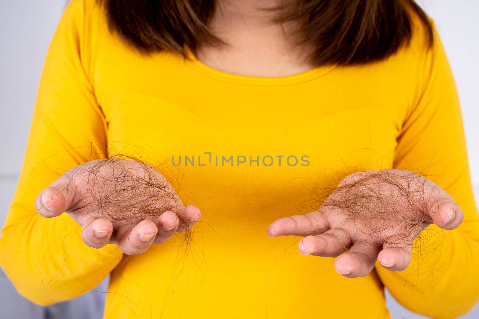 Hair fall problem, closeup hand holding problem hair. Healthcare medical or daily life concept.