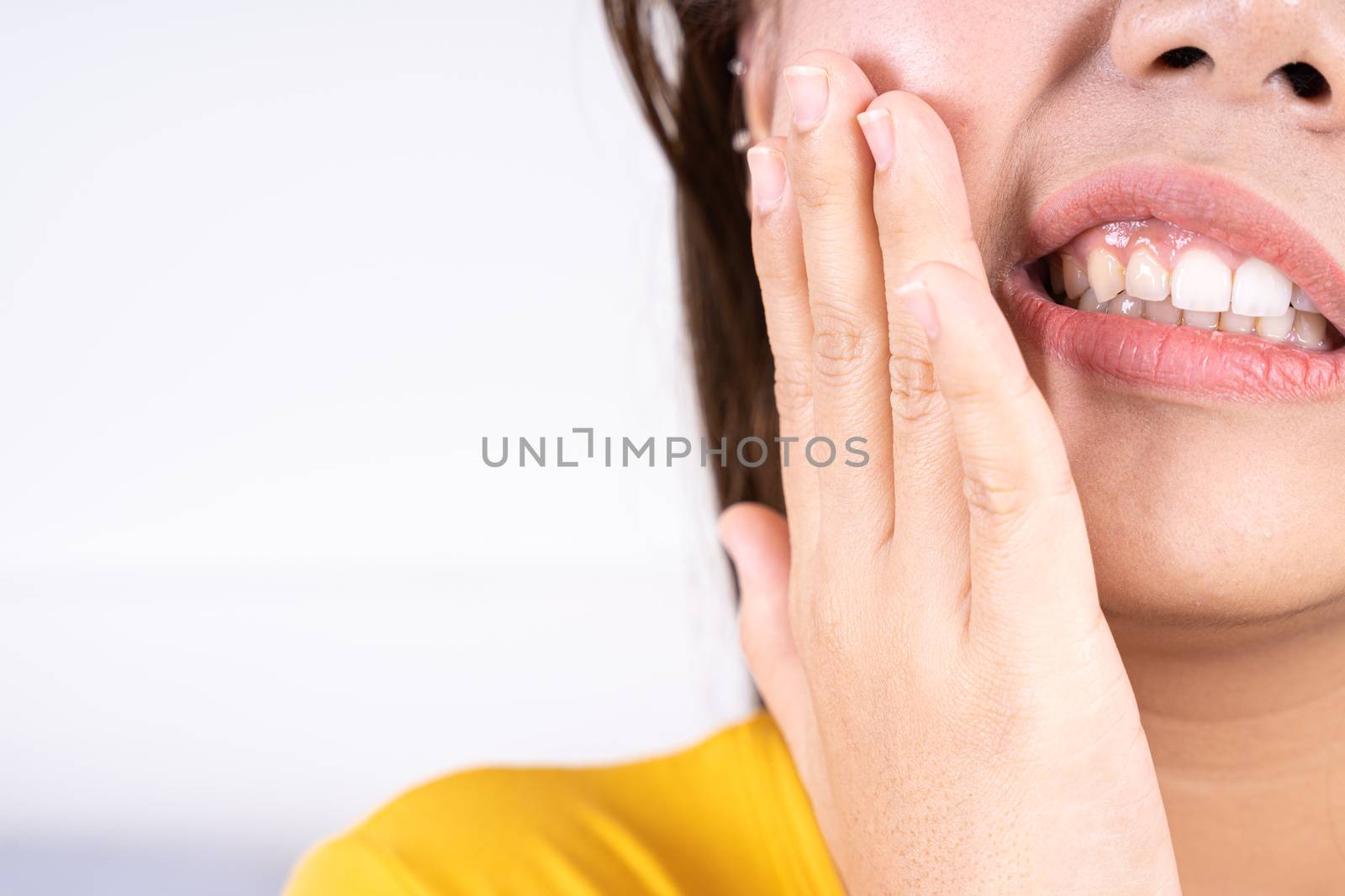 Woman suffering from toothache, hand touching wisdom tooth. Dental, healthcare concept by mikesaran