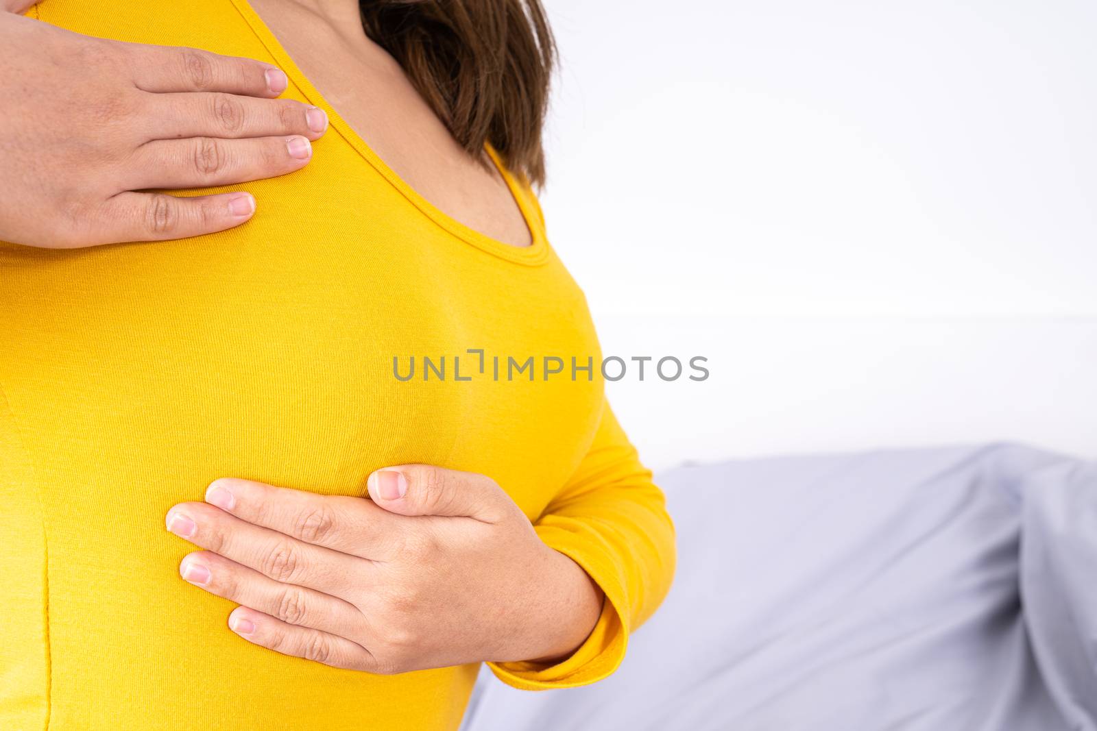 Woman hands doing breast self exam for checking lumps and signs of breast cancer. Medical, healthcare for advertising concept.