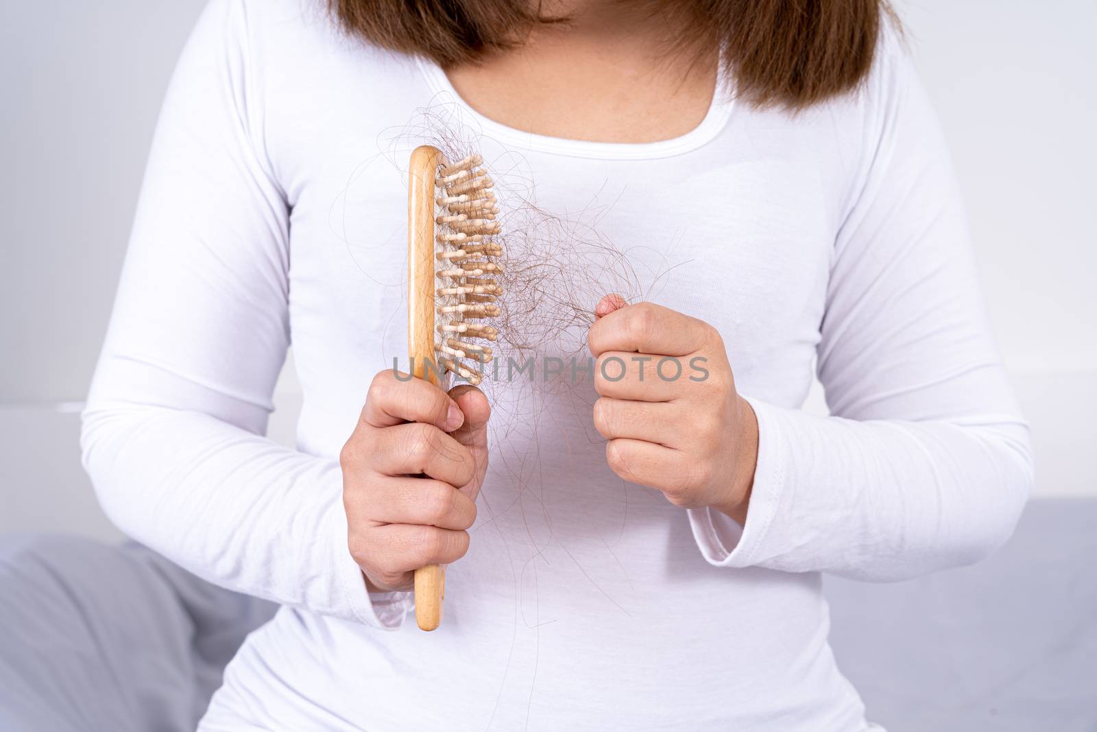 Hair fall problem, closeup hand holding comb and problem hair. Healthcare medical or daily life concept.