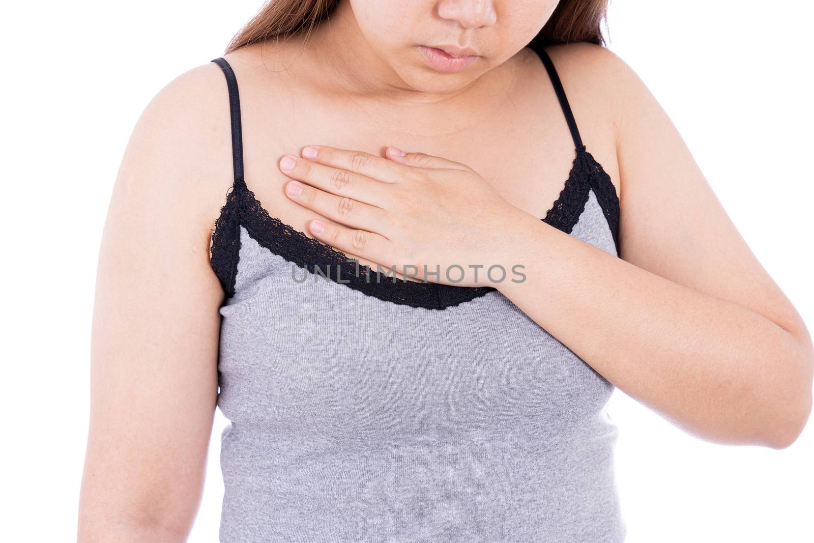 Woman touching her heart or chest isolated white background. Healthcare medical or daily life concept. by mikesaran