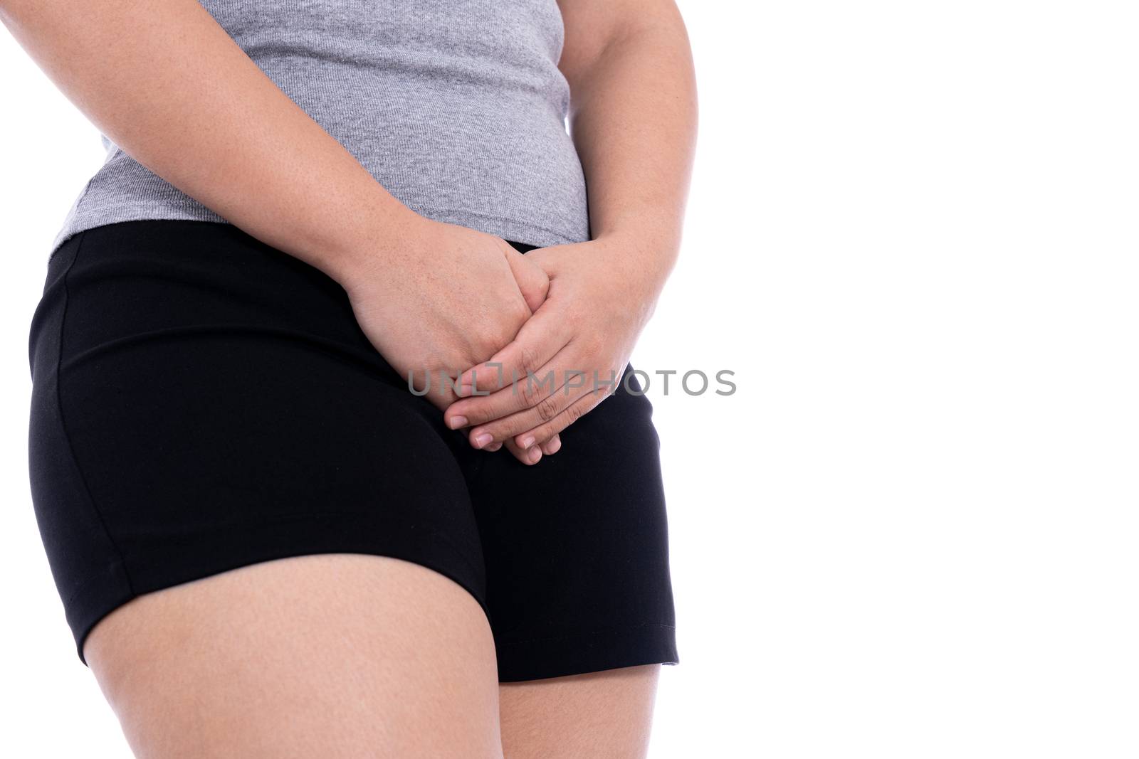 Woman hands holding her crotch suffering from painful stomachache isolated white background. Medical, healthcare for advertising concept.