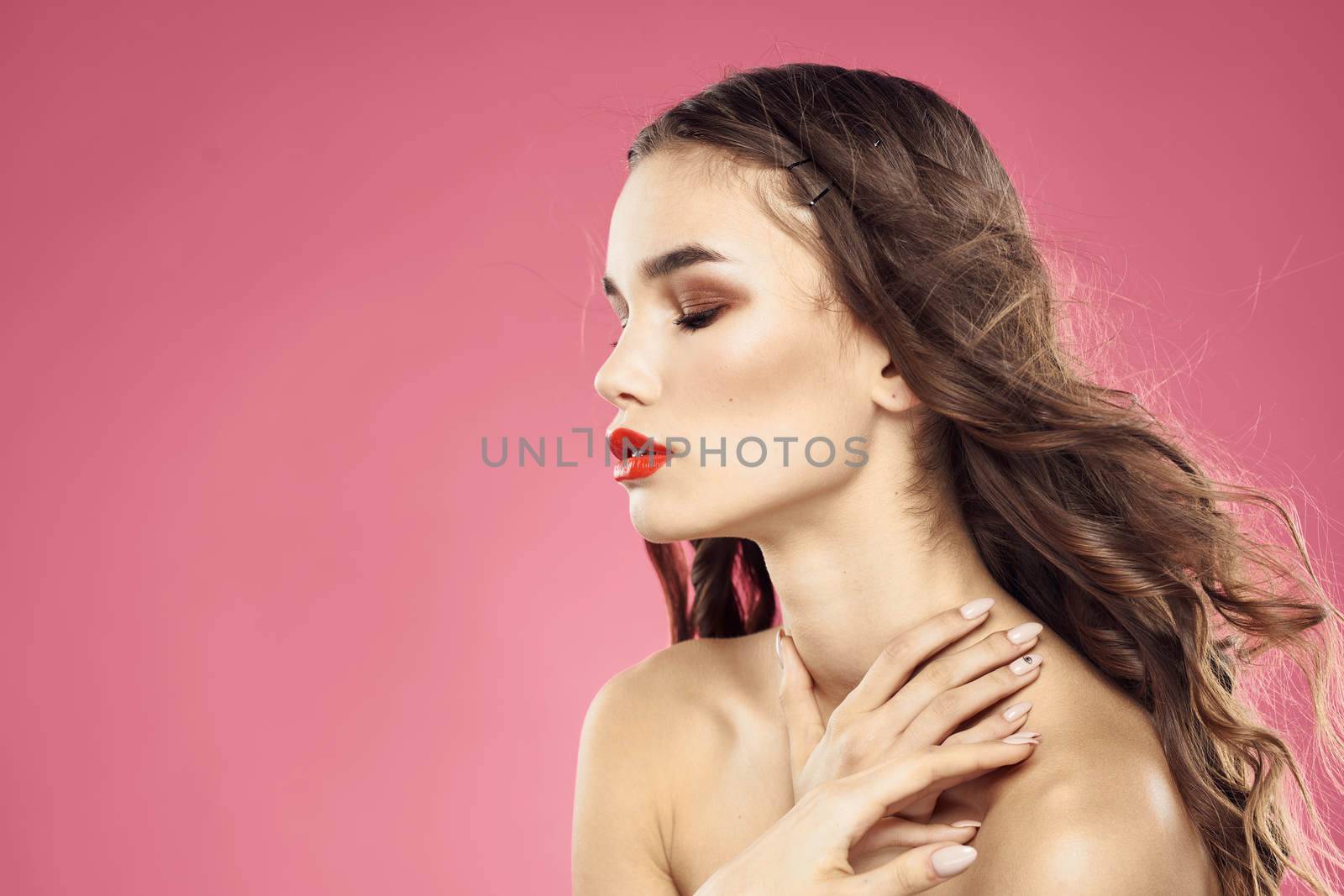Beautiful woman with red lips on a pink background nude shoulders cropped view by SHOTPRIME