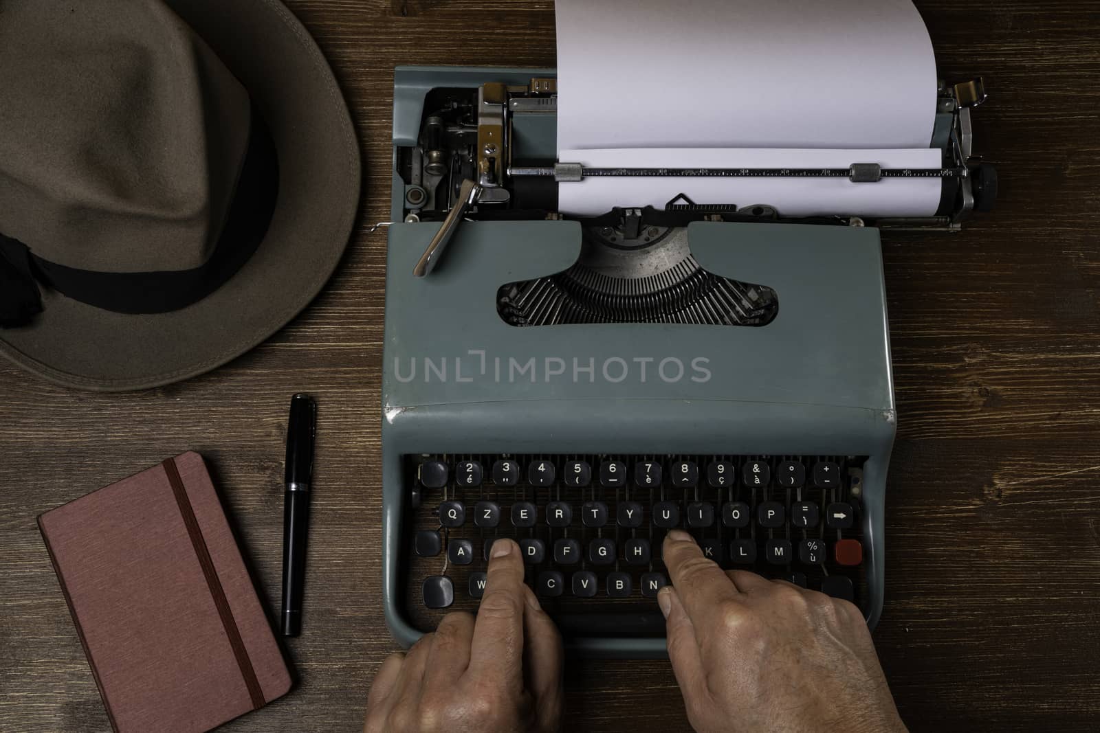 a man while writing with an old typewriter