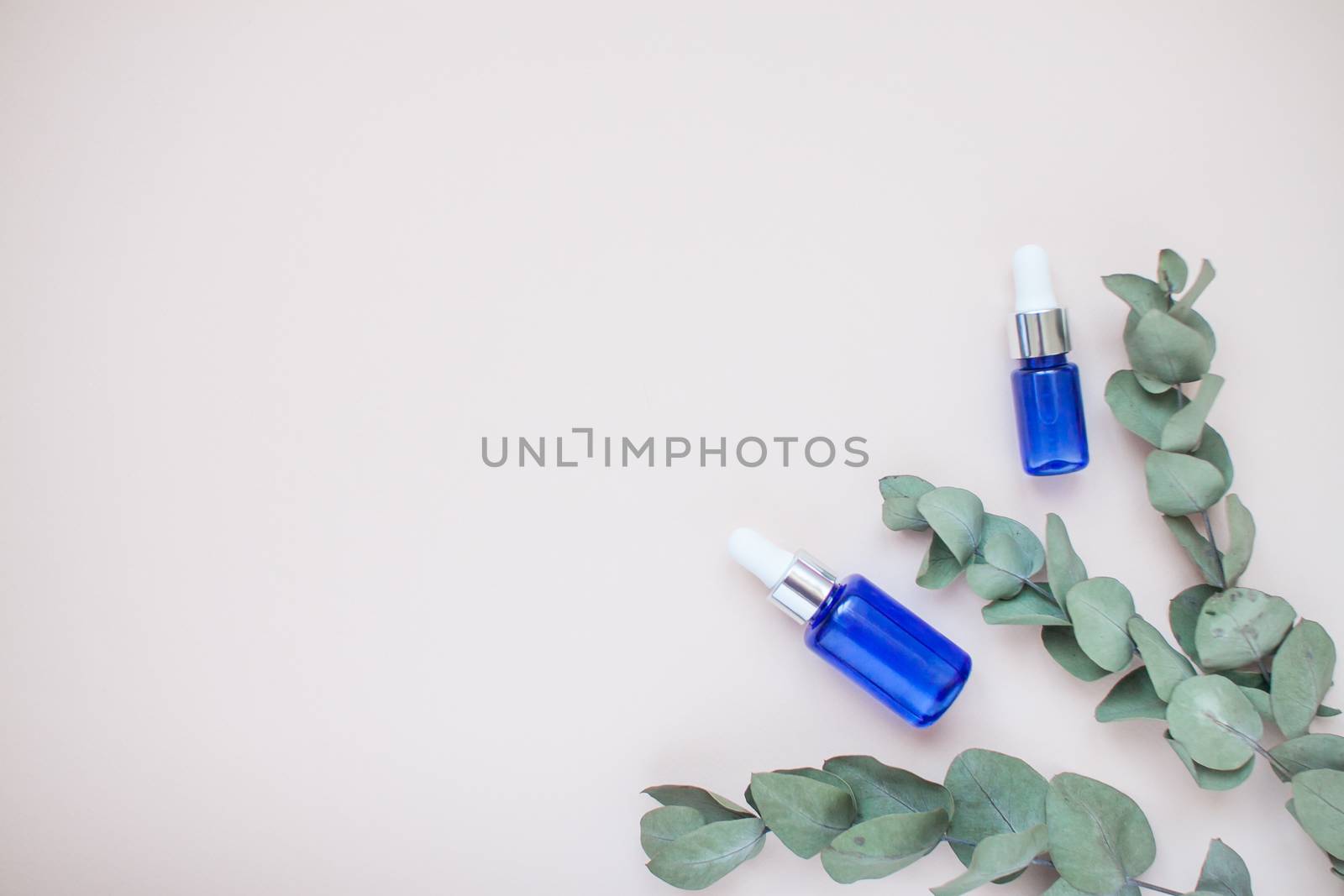Bottles with face serum on a light background. Beauty industry. Layout