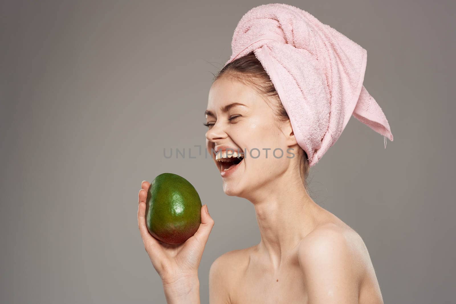 Cheerful woman bare shoulders clean skin cropped view gray background by SHOTPRIME