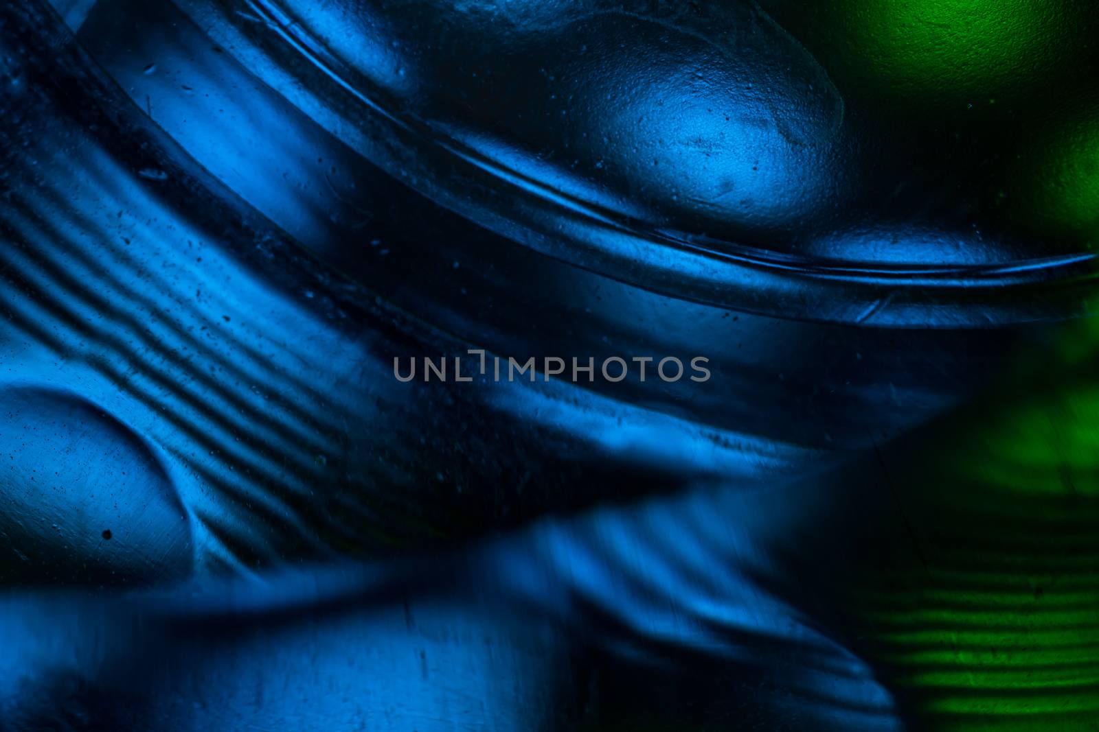 Abstract colorful backdrop with oil drops and waves on water sur by vladispas