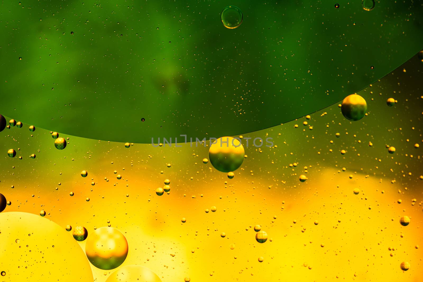 Abstract colorful backdrop with oil drops and waves on water sur by vladispas