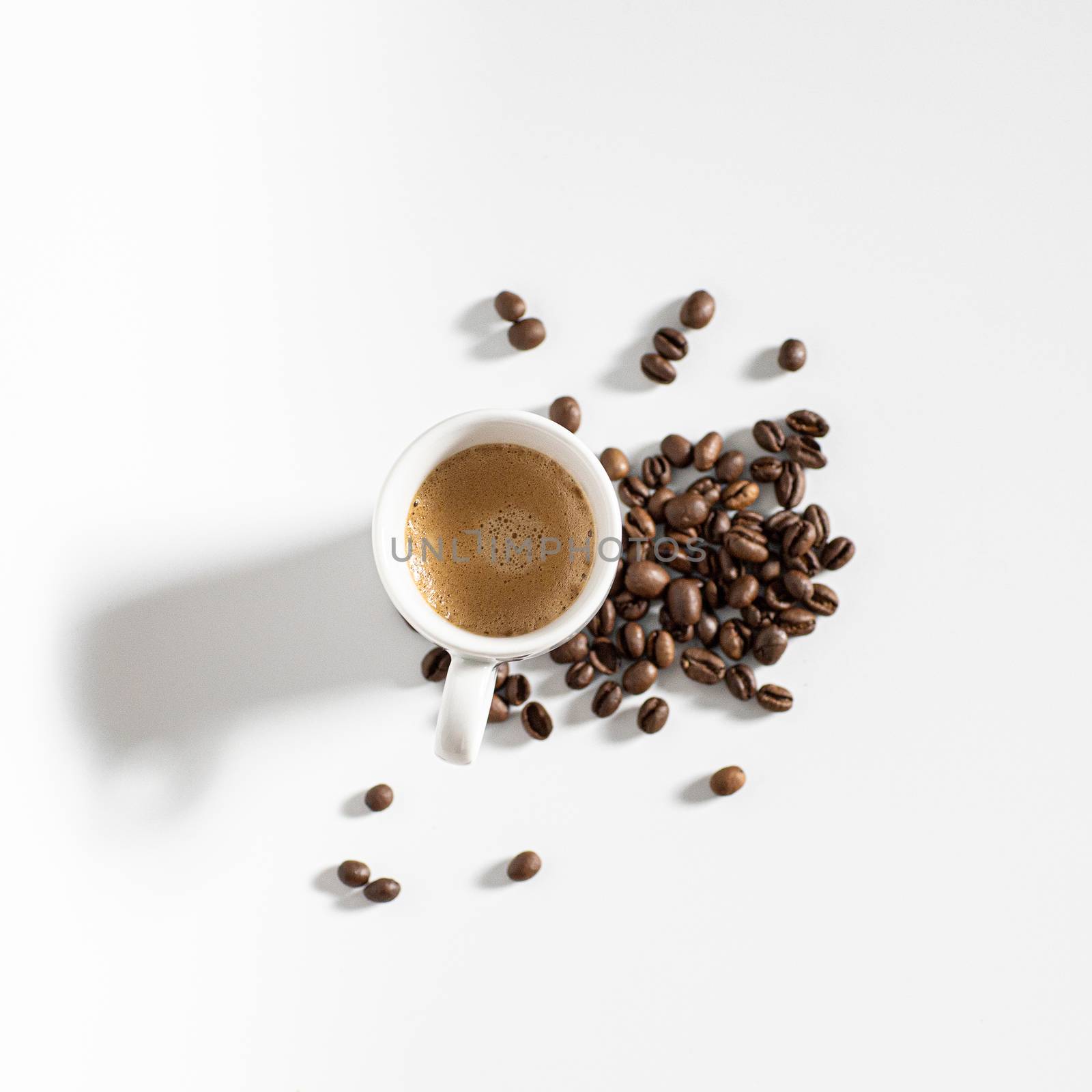 full coffee cup on white background with brown beans