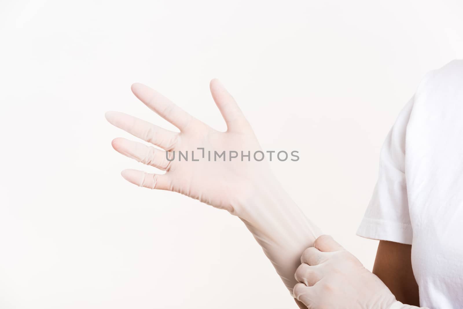 Woman wearing and putting hand to white rubber latex surgical medical glove for doctor, studio shot isolated on white background, Hospital medical infection control concept