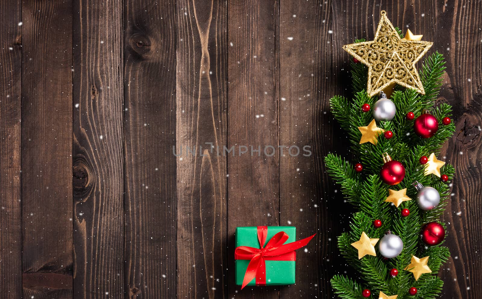 Beautiful Christmas green tree fresh fir branches and ornaments gift box and the star in-studio shot on black wooden background with copy space, New year card concept