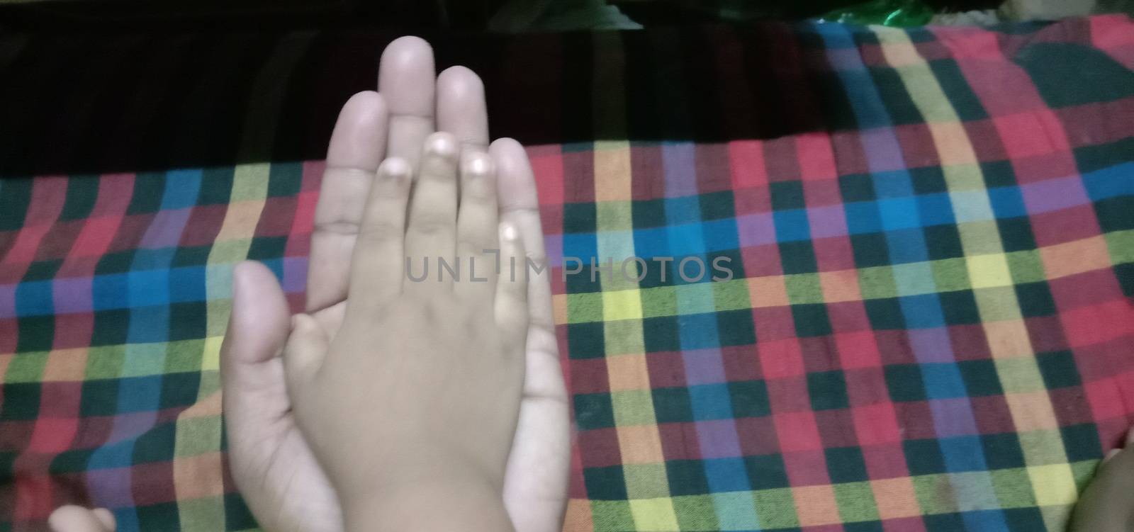 child and father hand closeup with trust