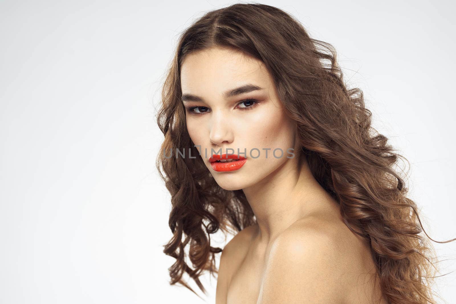 Beautiful woman with drawn swords bright makeup glamor close-up light background. High quality photo