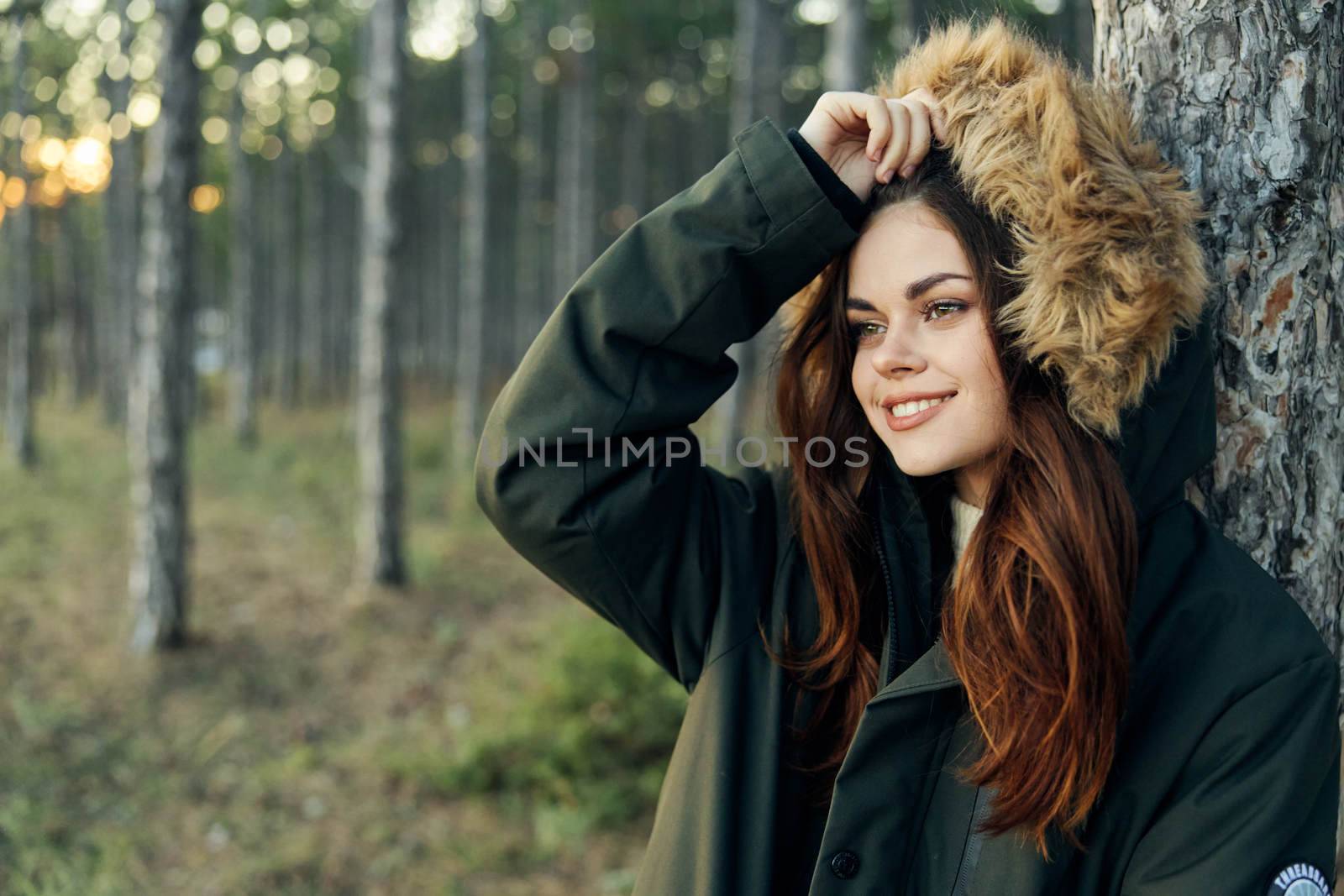 Woman in the autumn forest near the fresh air tree. High quality photo