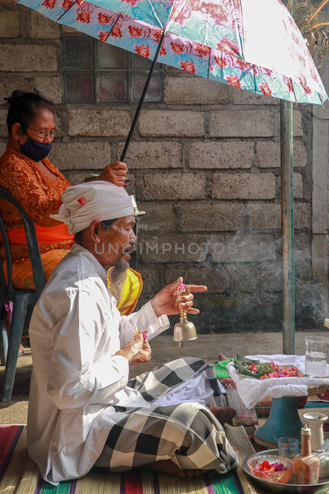 alinese Brahman performing morning rituals in the Bali temple, Indonesia.