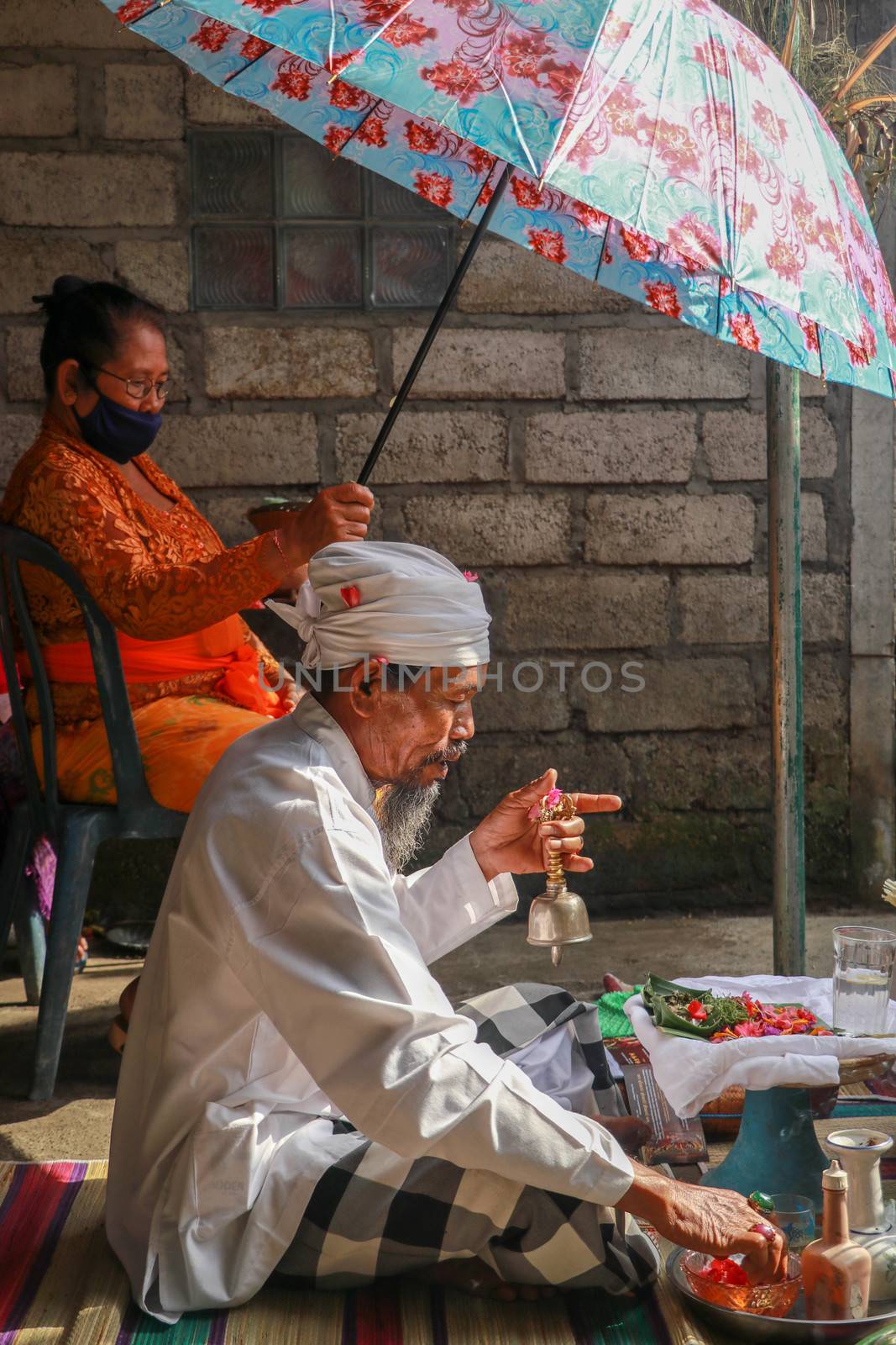 alinese Brahman performing morning rituals in the Bali temple, Indonesia by Sanatana2008