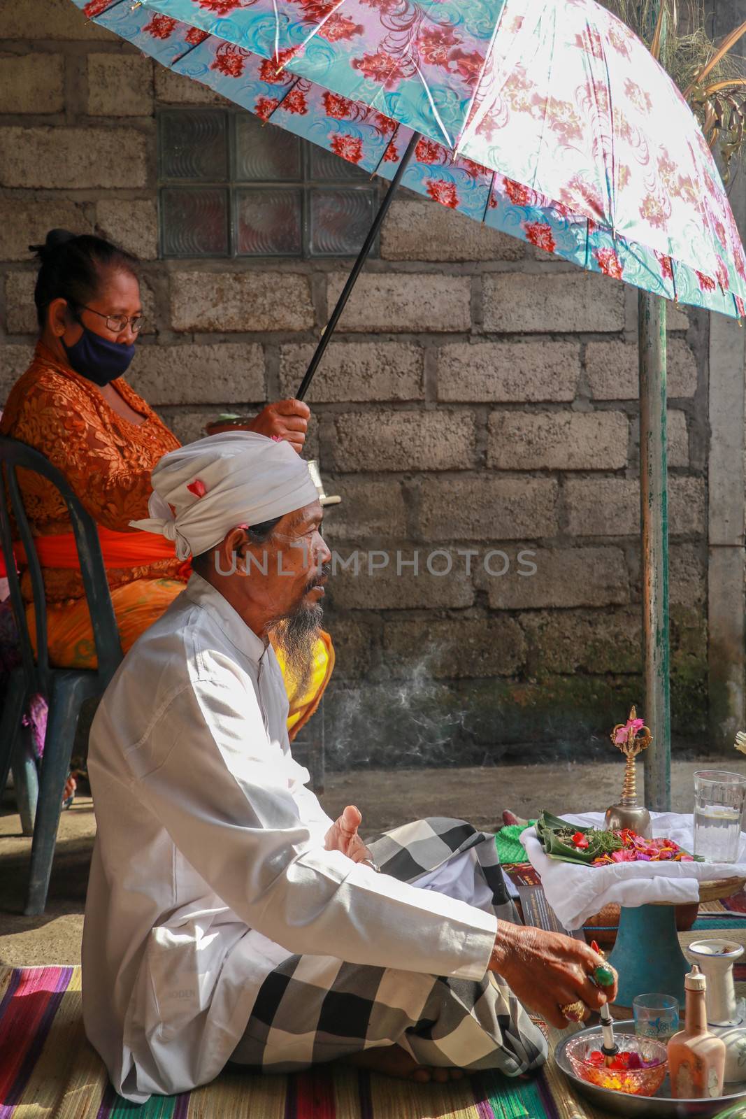 alinese Brahman performing morning rituals in the Bali temple, Indonesia.