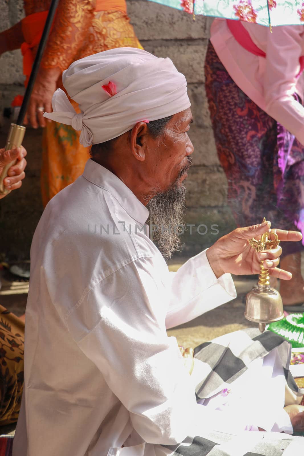 Closeup photograph of a Balinese Hindu high priest conducting a Ngaben ceremony in Ubud, Denpasar, Bali, Indonesia by Sanatana2008