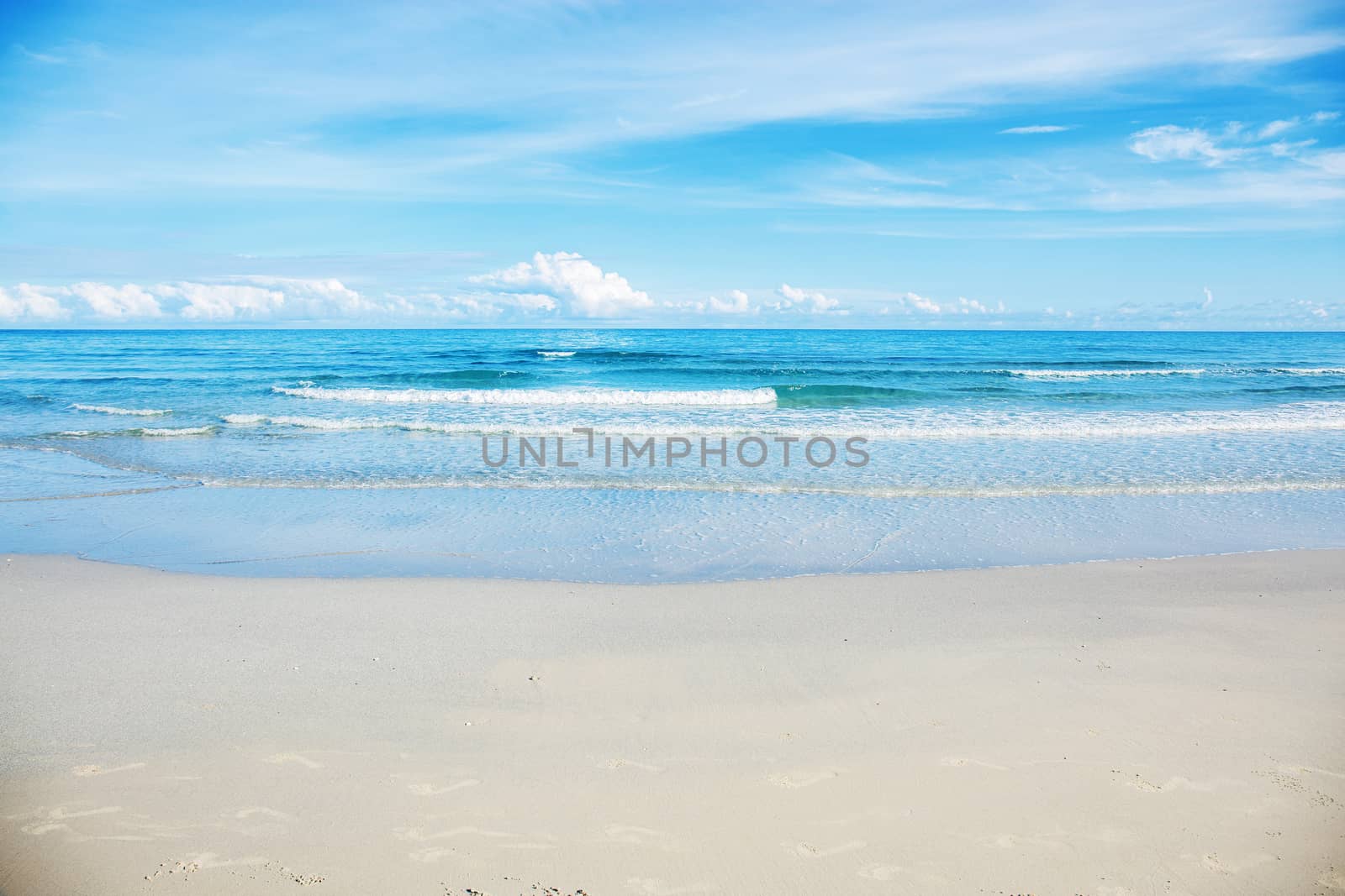 White of sand beach at sea with the blue sky.