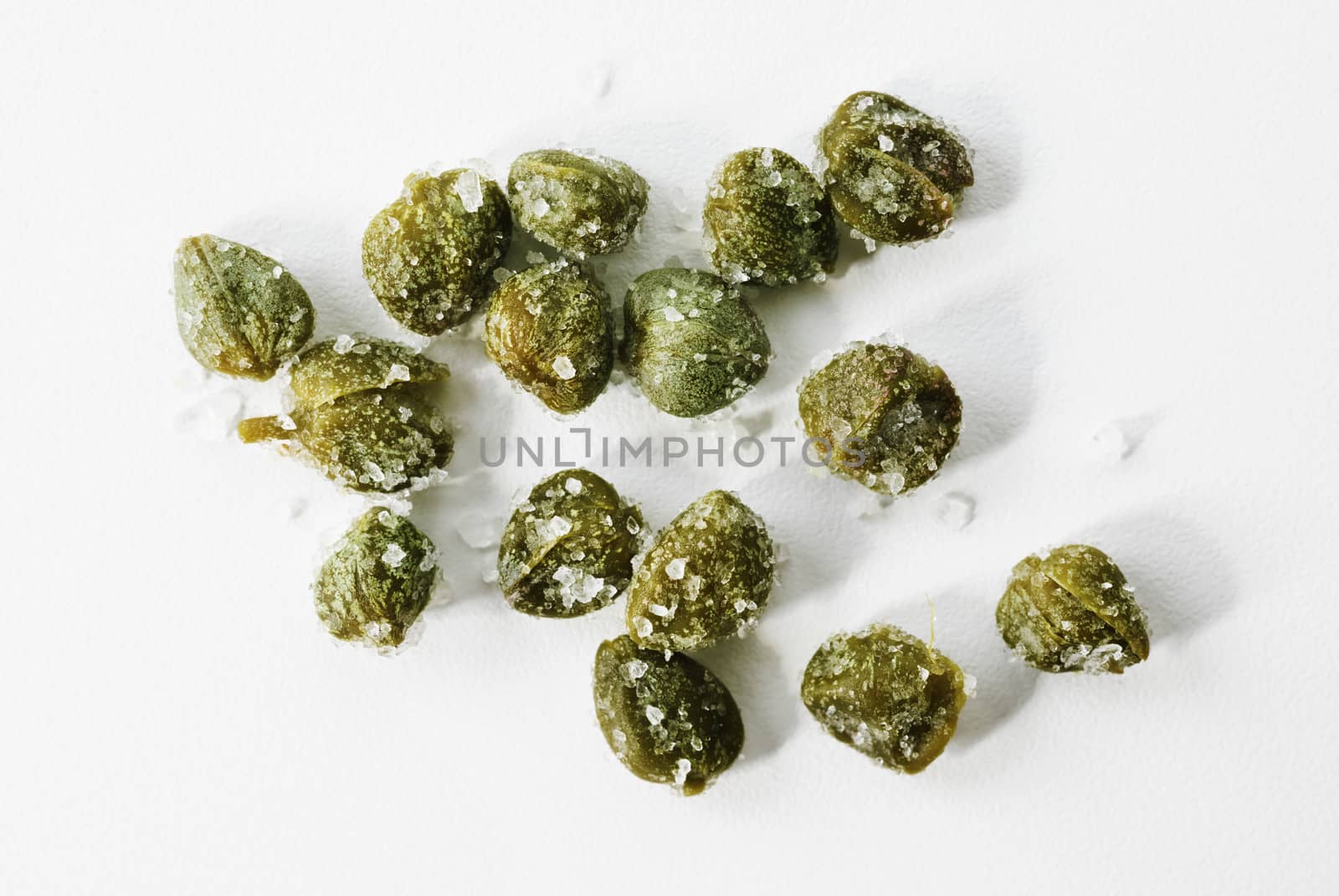 Beautiful green salted capers on white background , 